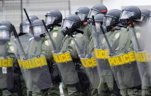 group-of-policemen-wih-shields-and-weapons-in-street